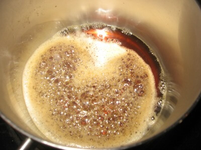 maple syrup in pot with small bubbles starting to form