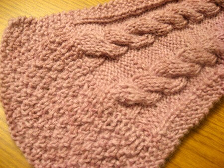 End of knitted scarf with pale lavender yarn dyed with berries