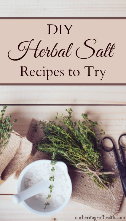 Salt in mortar with pestle with bundle of herbs and pair of scissors on table